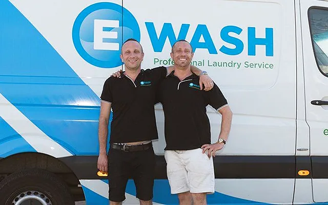 David and Leonard Gould standing in front of an eWASH laundry van