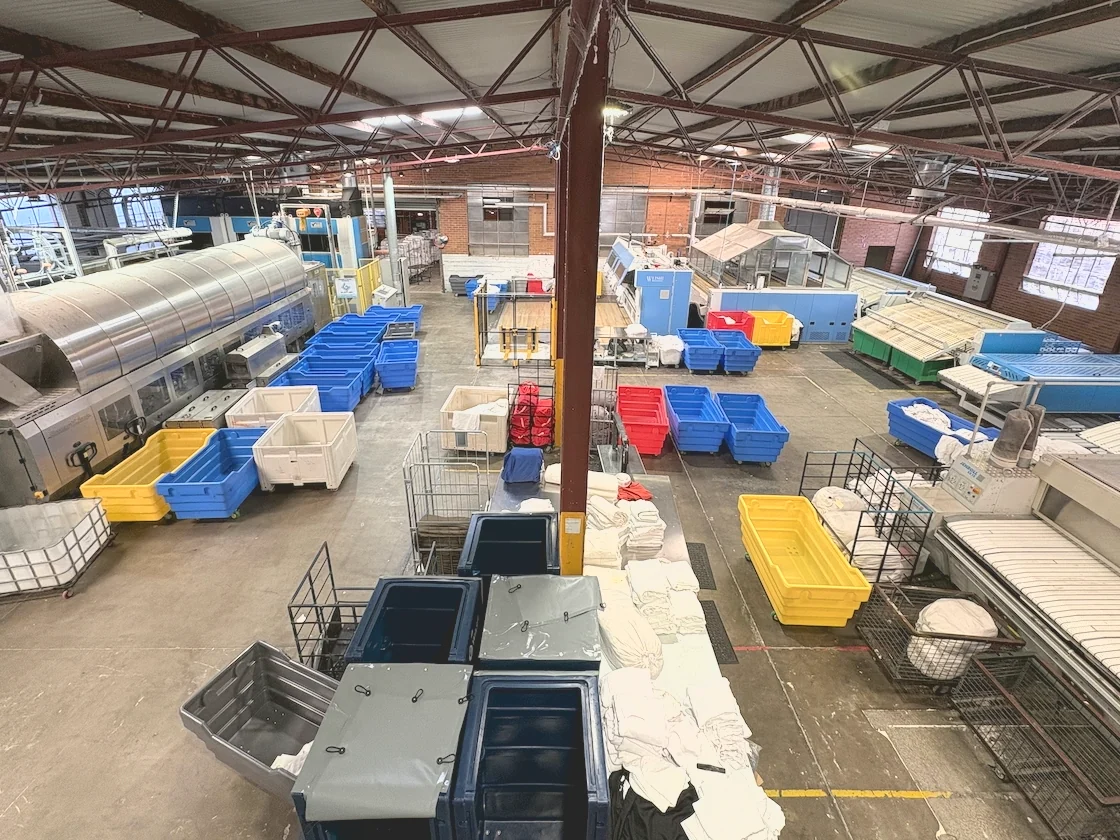 The eWASH laundry floor at Moorabbin seen from above, with the washing line, linen trolleys in use and finishing equipment